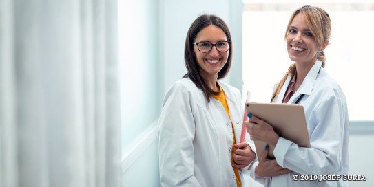 zwei Ärztinnen mit Tablet lächeln